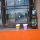 Czech popular Beer Radegast served from former joghurt cups on the window sill of a roadside grocery-liquer store